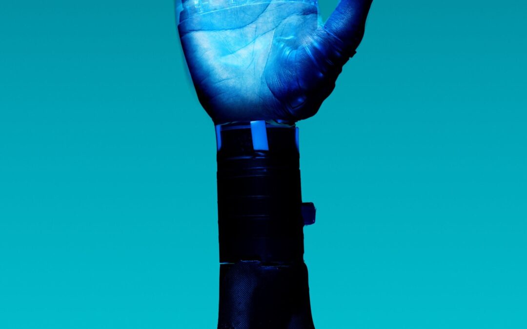 alt="Free Prosthetic Arm on Blue Background Stock Photo"