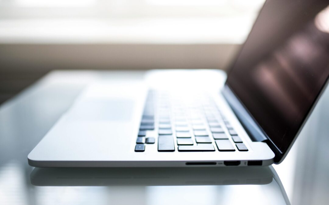 Free Elegant side view of a laptop on a glossy table with natural lighting indoors. Stock Photo